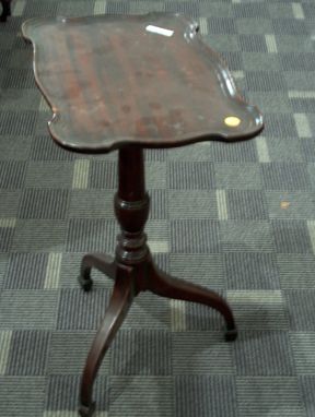 TWO PIECE MAHOGANY TILT TOP TEA TABLES 20th c. Wi: TWO PIECE MAHOGANY TILT TOP TEA TABLES 20th c. With shaped molded tops over turned supports on tripod legs. H: 25 1/2 in and 24 in.