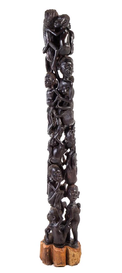 * An African Carved Wood Totem Height 65 inches.: * An African Carved Wood Totem 20th century set on a naturalistic base. Height 65 inches. Estimate $300-500