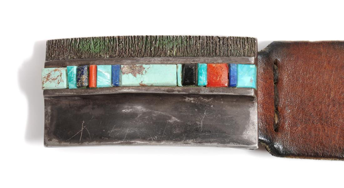 Hopi Style Silver and Multi-Stone Inlay Belt Buckle: Hopi Style Silver and Multi-Stone Inlay Belt Buckle on a leather belt with stamped silver roundels. Height of buckle 1 7/8 x width 3 1/2 inches Estimate $400-600 Length of belt 41 inches Purportedly f