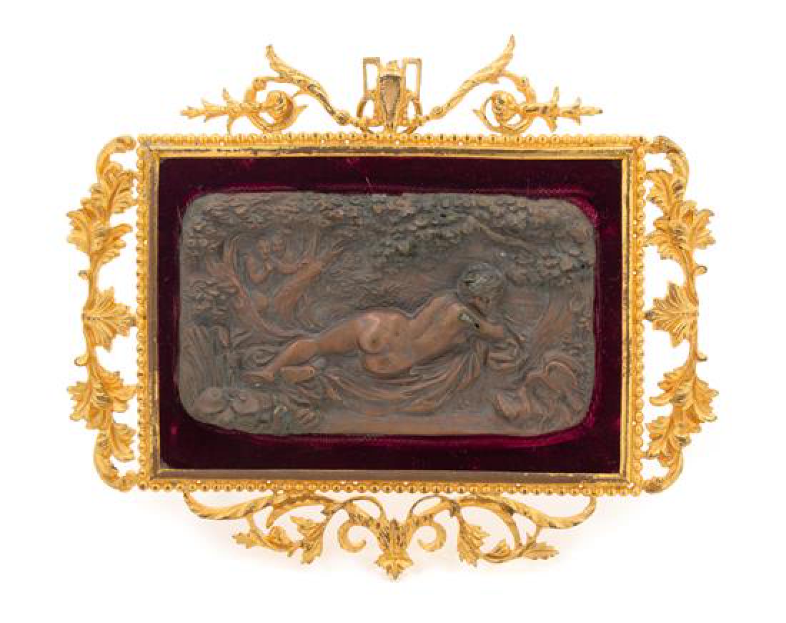 * A Continental Gilt Bronze Relief Plaque Height: * A Continental Gilt Bronze Relief Plaque 19th century cast to show a reclining nude in a forest with two satyrs in the background. Height overall 6 5/8 x width 7 3/4 inches. Estimate $100-200 Propert
