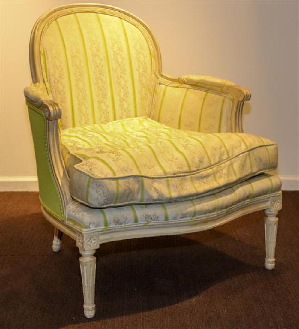 A Louis XVI Style Painted Bergere Height 36 inches.: A Louis XVI Style Painted Bergere early 20th century having a domed channel molded crest rail above the padded back, arms and cushion seat, raised on fluted cylindrical tapering legs. Height 36 inches