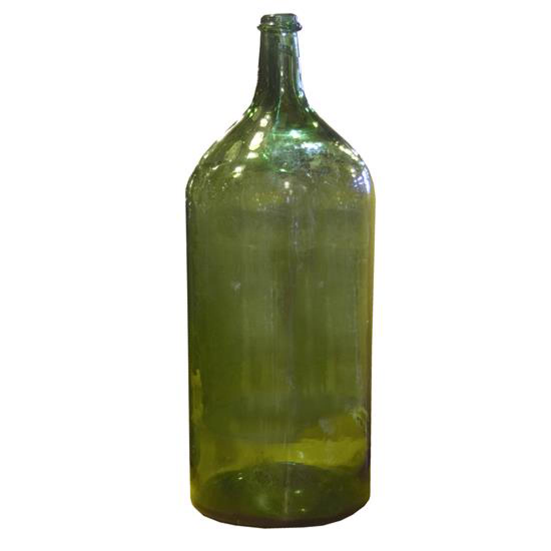 A Glass Wine Bottle 8.5" W x 8.5" D x 25" H: A Glass Wine Bottle italy, 20th century 8.5" W x 8.5" D x 25" H Estimate $100-200