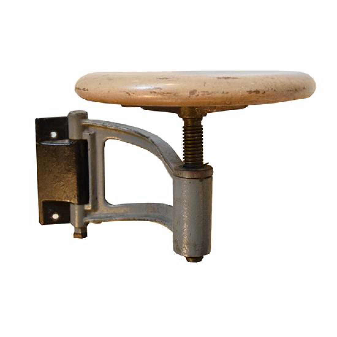 An Iron and Wood Swing Arm Stool 20" W x 11" D x 12 "H: An Iron and Wood Swing Arm Stool united states, circa 1930 20" W x 11" D x 12 "H Estimate $100-200