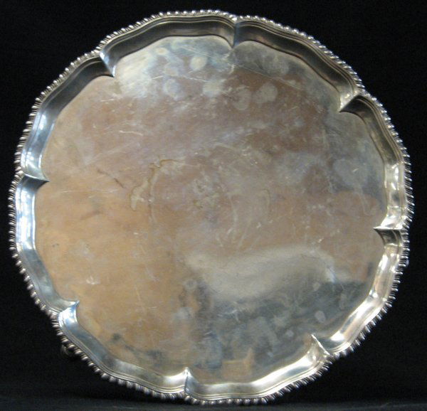 George II sterling silver salver, robert rew, lon: George II sterling silver salver robert rew, london 1759 With a gadrooned shaped border, raised on stepped pad feet. Diam: 10 3/4 in. 21 oz.