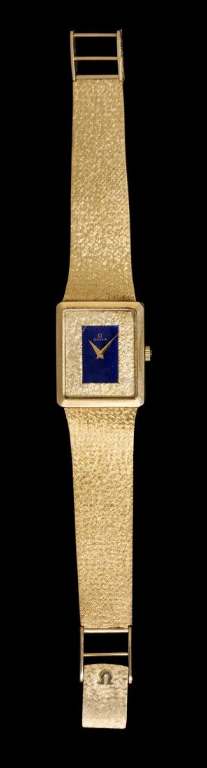 A 14 Karat Yellow Gold and Lapis Lazuli Wristwatch,: A 14 Karat Yellow Gold and Lapis Lazuli Wristwatch, Omega, 23.00 x 28.00 mm case dimensions, Florentine finish dial with center lapis lazuli inlaid plaque signed OMEGA, gold pitched dauphine hands, sn