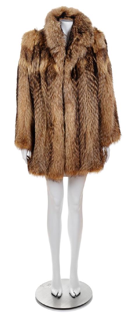 A Raccoon Fur Coat, Size small.: A Raccoon Fur Coat, with a notched collar, hook and eye front closure, slip pockets and fully lined. Unlabeled. Size small. Estimate $200-300 Property from the Collection of Carole Last, Racine, Wisco