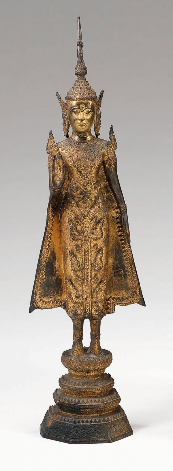 Good Thai gilt metal figure of Sakyamuni, 19th c: Good Thai gilt metal figure of Sakyamuni 19th century Standing, hand raised in abhaya mudra, face in expression of joyful meditation, over a graduated plinth. H: 29 1/2 in. PROVENANCE: From a Private