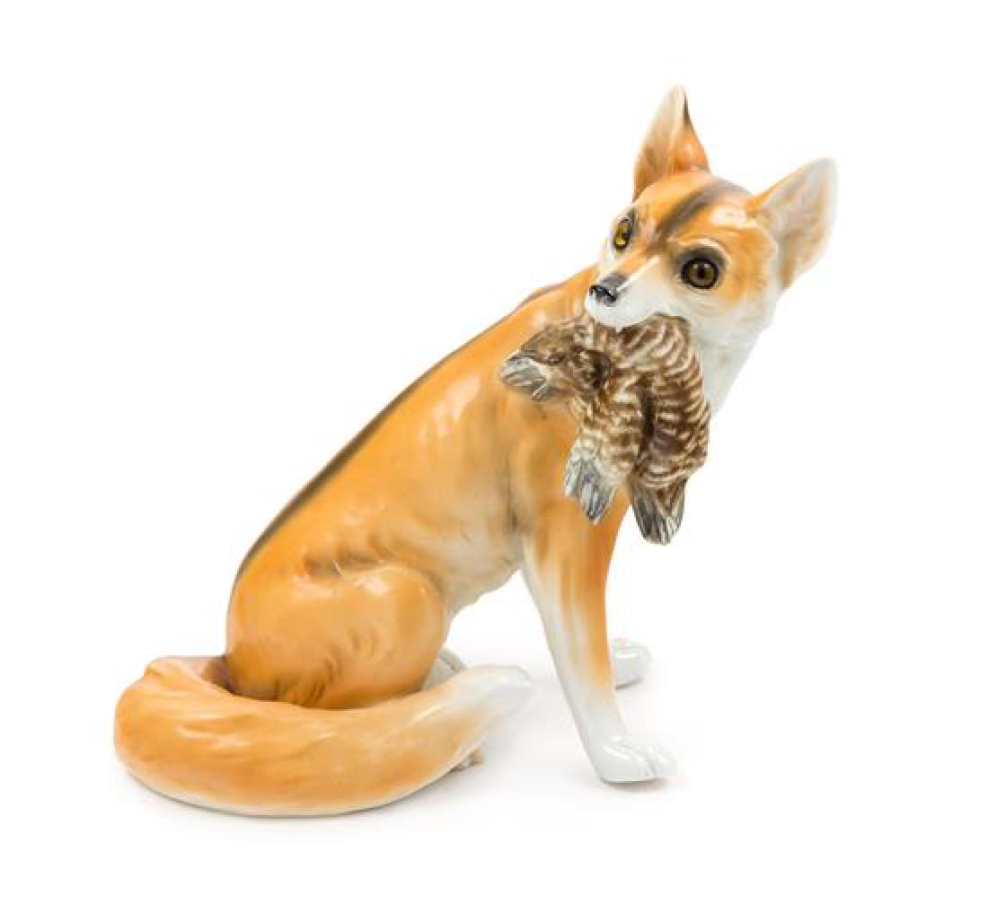 A Capodimonte Porcelain Fox Figure Height 11 1/2: A Capodimonte Porcelain Fox Figure late 19th/early 20th century modeled to show a fox clutching its prey, with glass eyes, having a Capodimonte mark in underglaze blue, incised marks and painted Saxe