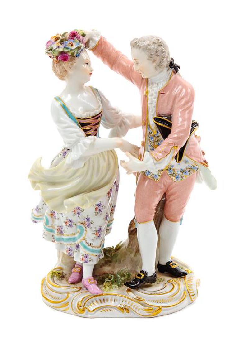 * A Meissen Porcelain Figural Group Height 6 inches.: * A Meissen Porcelain Figural Group late 19th/early 20th century modeled to show a dancing couple, with crossed swords in underglaze blue, impressed and incised marks to the underside. Height 6 inches
