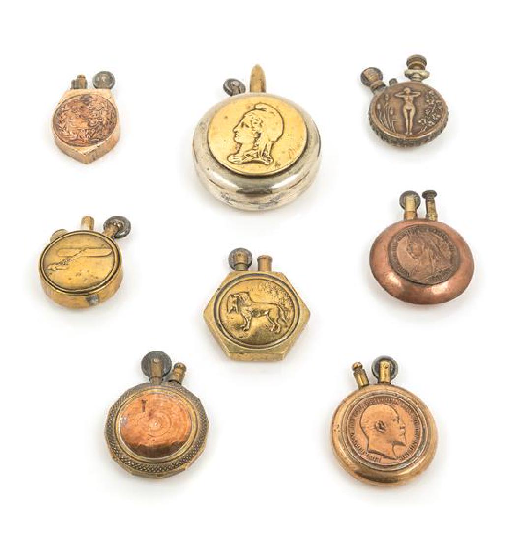 A Group of Eight Mixed Metal Circular Pocket Lighters (1 of 2)