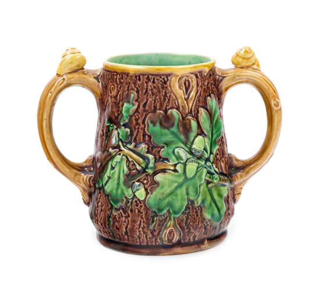 A Minton Majolica Spooner Height 4 5/8 inches.: A Minton Majolica Spooner 19th century the twin handles mounted with snails, the body modeled to show oak leaves, with impressed marks to the underside. Height 4 5/8 inches. Estimate $80-120