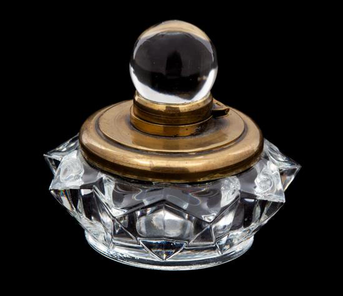 A Brass Mounted Glass Inkwell Height 3 1/4 inches.: A Brass Mounted Glass Inkwell 20th century having a glass ball finial, star form base. Height 3 1/4 inches. Estimate $80-120 Property from the Collection of M. Anthony Greene, Atlanta, Georgia
