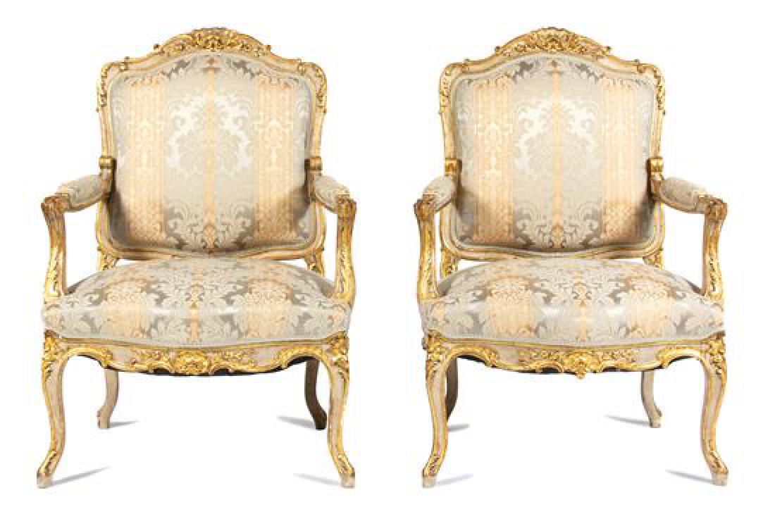 Set of Four Louis XV Style Painted and Parcel Gilt: Set of Four Louis XV Style Painted and Parcel Gilt Fauteuils 19th/20th century having upholstered back, seat and arm rests in a gold/silver damask upholstery. Height 41 1/2 inches. Estimate $1,200-1,8