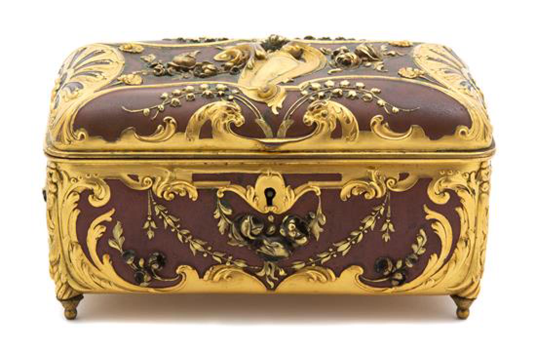 A French Art Nouveau Gilt Bronze and Brown Enamel Jewel: A French Art Nouveau Gilt Bronze and Brown Enamel Jewel Box late 19th century having overall foliate and scrollwork decoration. Height 4 x width 7 x depth 4 inches. Estimate $500-700 Property from the