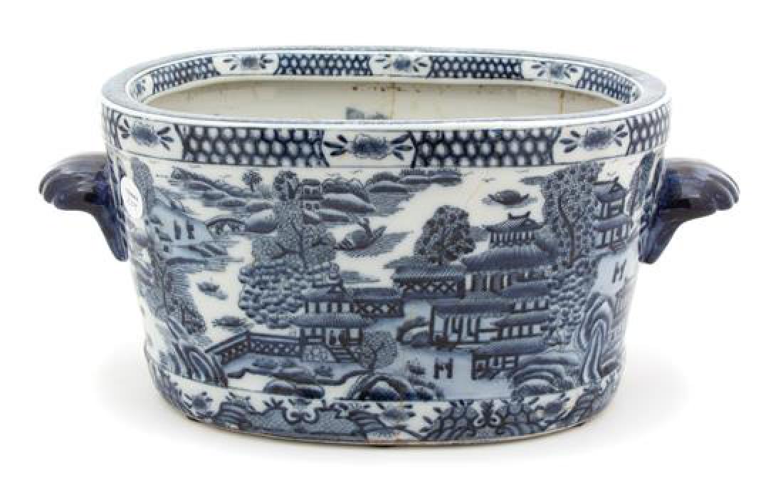 A Chinese Export Blue and White Porcelain Jardiniere: A Chinese Export Blue and White Porcelain Jardiniere 19th century Height 8 x length 18 inches. Estimate $80-120 Property from the Collection of M. Anthony Greene, Atlanta, Georgia Multiple age cracks,