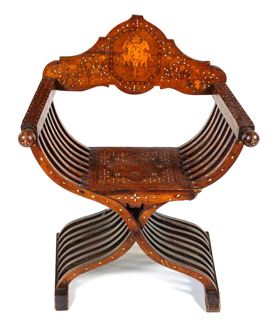 * An Italian Mother-of-Pearl, Basswood and Ebony Inlaid: * An Italian Mother-of-Pearl, Basswood and Ebony Inlaid Walnut Savonarola Chair late 19th/early 20th century of typical form, the crest inlaid to show a crest among foliate scrolls. Height 36 x width