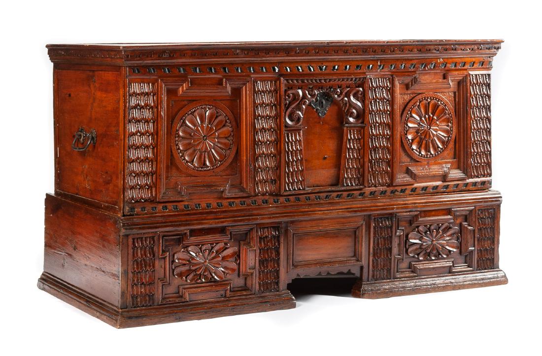 A Northern European Carved Cassone on Stand Height 35 x: A Northern European Carved Cassone on Stand 18th century the case and stand each carved to show paterae within shaped panels, the cassone mounted with bail handles. Height 35 x width 60 x depth 24 3/4