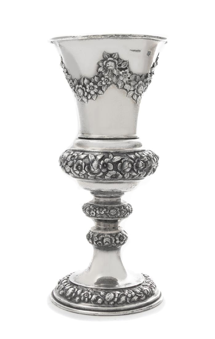 * An Austrian Silver Chalice, J. Reiner, Vienna, 1847,: * An Austrian Silver Chalice J. Reiner, Vienna, 1847 the tapering cup worked to show repousee floral swags, raised on a similarly decorated knopped stem and circular foot. marked on base above floral 