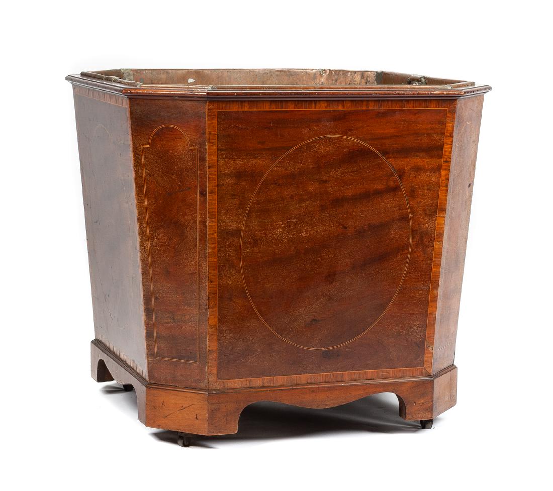A Large English Mahogany Jardiniere Height 31 1/4 x: A Large English Mahogany Jardiniere late 19th/early 20th century of tapering squared form with canted corners and inlaid stringing, raised on bracket feet ending in casters. Height 31 1/4 x width 34 x
