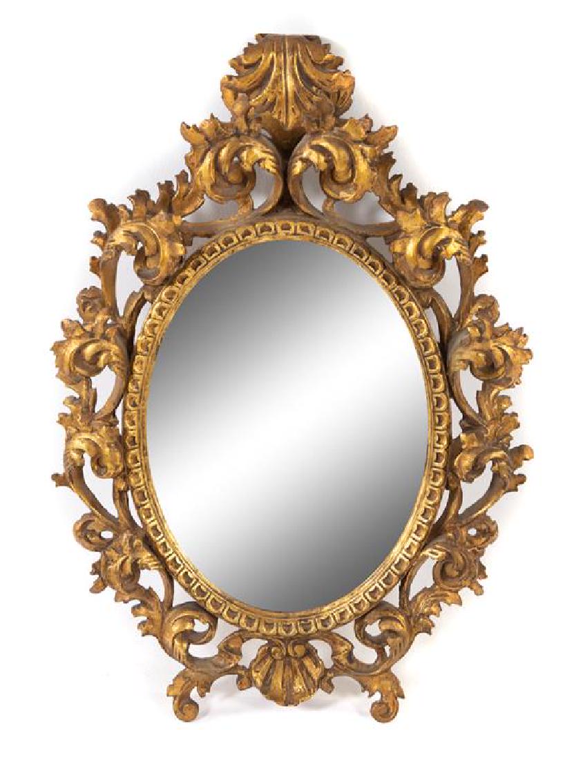 A Continental Giltwood Oval Mirror: A Continental Giltwood Oval Mirror 20th century Length 28 1/2 inches overall. Estimate $400-600