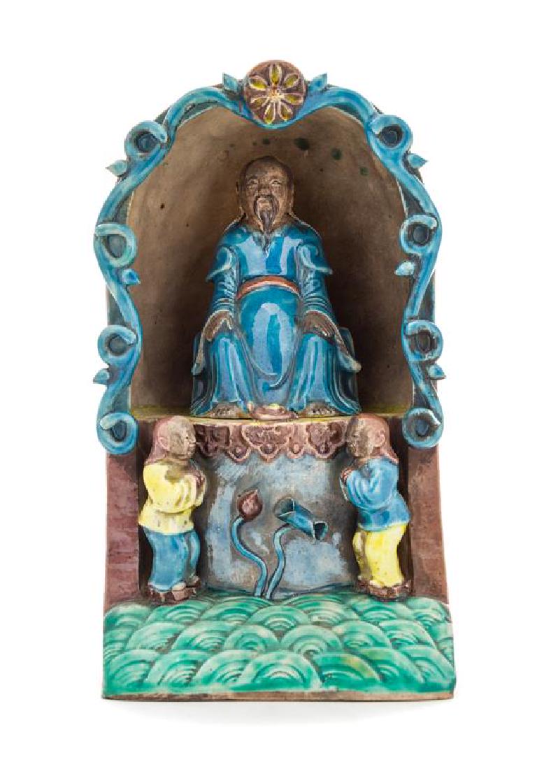 * A Turquoise, Aubergine, Yellow and Green Glazed: * A Turquoise, Aubergine, Yellow and Green Glazed Porcelain Shrine likely ming dynasty (1368-1644) enclosing the Daoist immortal, Taishang yuanjun seated atop a high throne flanked by two boy attendan