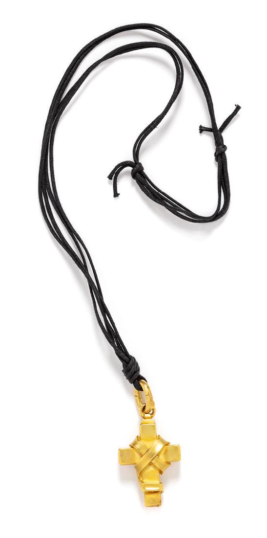 An 18 Karat Yellow Gold Cross Pendant/Necklace,: An 18 Karat Yellow Gold Cross Pendant/Necklace, Kieselstein-Cord, Circa 1991, in a bound cross design with matte finish, suspended by a woven leather cord necklace. Stamp: B. KIESELSTEIN CORD 1991 (ma