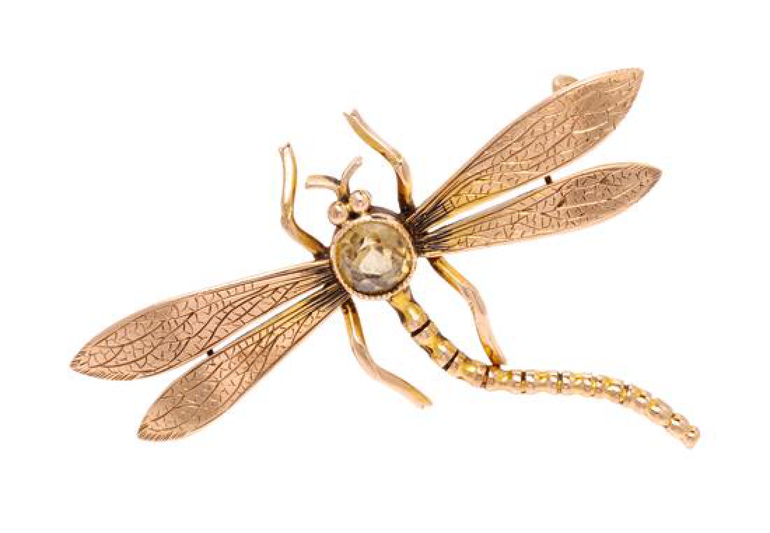 * A Victorian 9 Karat Rose Gold and Brown Zircon: * A Victorian 9 Karat Rose Gold and Brown Zircon Dragonfly Brooch, containing one old mine cut brown zircon measuring approximately 5.90 mm in diameter, with hand engraved wings. Stamp: 9 CT (1983 scr