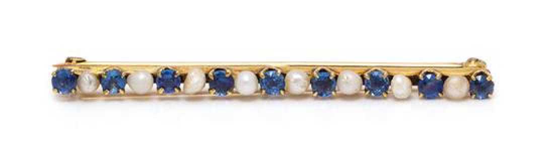 An Edwardian 14 Karat Yellow Gold, Sapphire and Seed: An Edwardian 14 Karat Yellow Gold, Sapphire and Seed Pearl Bar Brooch, Charles Keller & Co., containing nine round mixed cut sapphires measuring approximately 2.75-2.90 mm in diameter alternating with