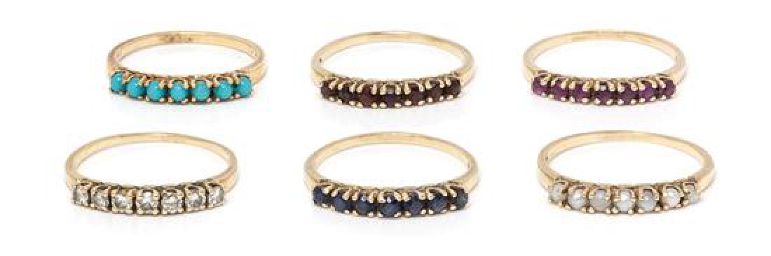 A Collection of 14 Karat Yellow Gold and Gemstone: A Collection of 14 Karat Yellow Gold and Gemstone Stacking Rings, consisting of a ring containing seven round mixed cut sapphires measuring approximately 2.33 mm in diameter, a ring containing seven c