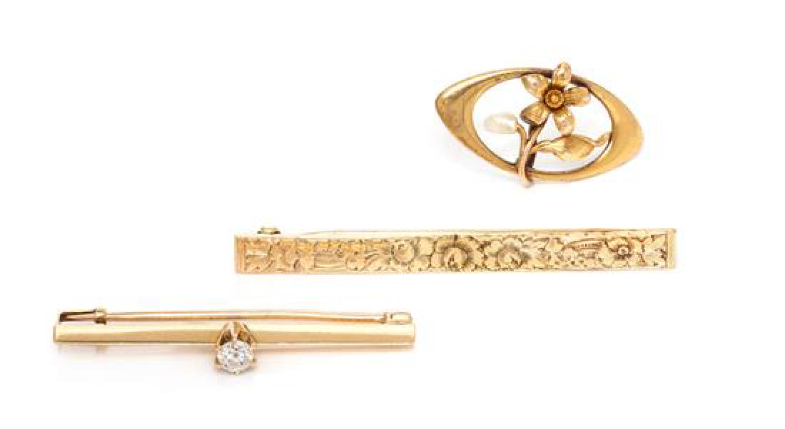 A Collection of Vintage Yellow Gold Brooches, 6.50: A Collection of Vintage Yellow Gold Brooches, consisting of a bar brooch containing one old European cut diamond weighing approximately 0.30 carat, a 14 karat gold bar brooch with an etched flower des