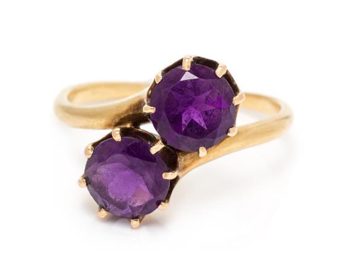 An Edwardian 18 Karat Yellow Gold and Amethyst Toi et: An Edwardian 18 Karat Yellow Gold and Amethyst Toi et Moi Ring, containing two round mixed cut amethyst measuring approximately 6.94-6.96 mm in diameter. Stamp: 18. 2.80 dwts. Estimate $250-350