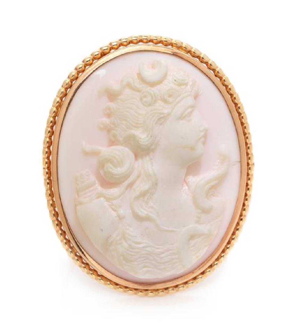 A Yellow Gold and Carved Shell Cameo Brooch, 9.00 dwts.: A Yellow Gold and Carved Shell Cameo Brooch, consisting of an oval carved shell of the goddess Persephone within beaded gold surround. 9.00 dwts. Estimate $50-70