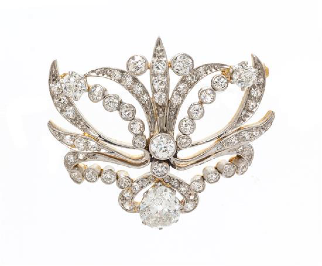 An Edwardian Platinum Topped Yellow Gold and Diamond: An Edwardian Platinum Topped Yellow Gold and Diamond Brooch, containing one antique pear shape brilliant cut diamond weighing approximately 0.94 carat and 62 old European, old mine and single cut diam