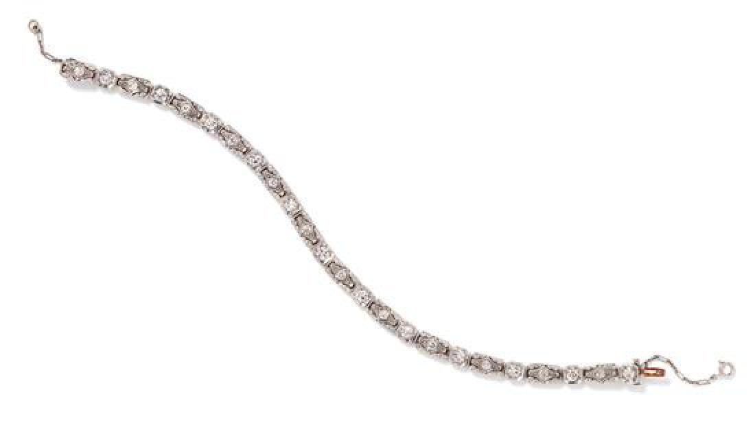 A Platinum and Diamond Line Bracelet, 11.85 dwts.: A Platinum and Diamond Line Bracelet, containing 24 transitional cut diamonds weighing approximately 2.15 carats total, strung underneath with a 14 karat white gold safety chain. Clasp stamp: 14K. 11.
