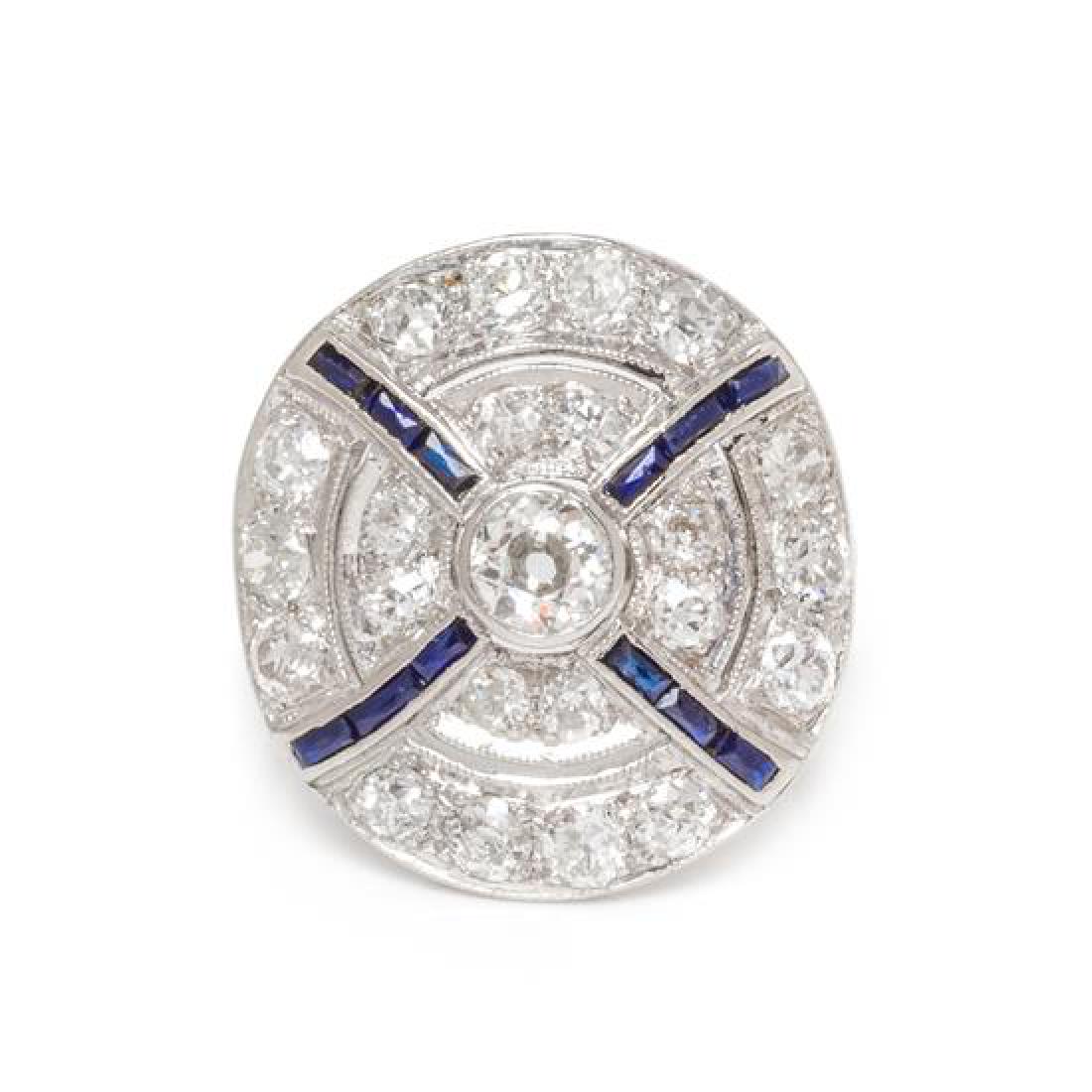 An Antique Platinum, White Gold, Diamond, and Sapphire: An Antique Platinum, White Gold, Diamond, and Sapphire Target Ring, containing one old European cut diamond weighing approximately 0.20 carat, 22 old European cut diamonds weighing approximately 1.00 