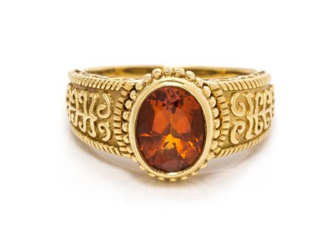 A Yellow Gold and Citrine Ring, Cynthia Bach, 6.60: A Yellow Gold and Citrine Ring, Cynthia Bach, containing one oval shape mixed cut citrine measuring approximately 9.50 x 7.30 x 5.45 mm with scrolling design detail. Stamp: (maker's mark for Cynthia B