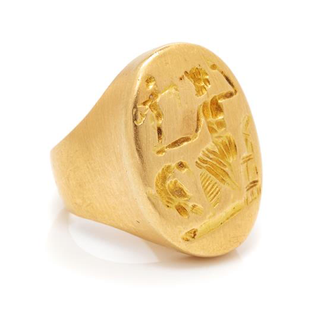 An 18 Karat Yellow Gold Ring, 6.80 dwts.: An 18 Karat Yellow Gold Ring, consisting of an oval carved intaglio top of a Classical motif. Stamp: K18. 6.80 dwts. Estimate $200-300