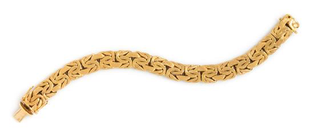 An 18 Karat Yellow Gold Bracelet, 61.15 dwts.: An 18 Karat Yellow Gold Bracelet, consisting of a domed byzantine link chain measuring approximately 11.00 mm wide with brushed finish. Stamp: 750 CB mod. dep. 61.15 dwts. Estimate $2,000-3,000