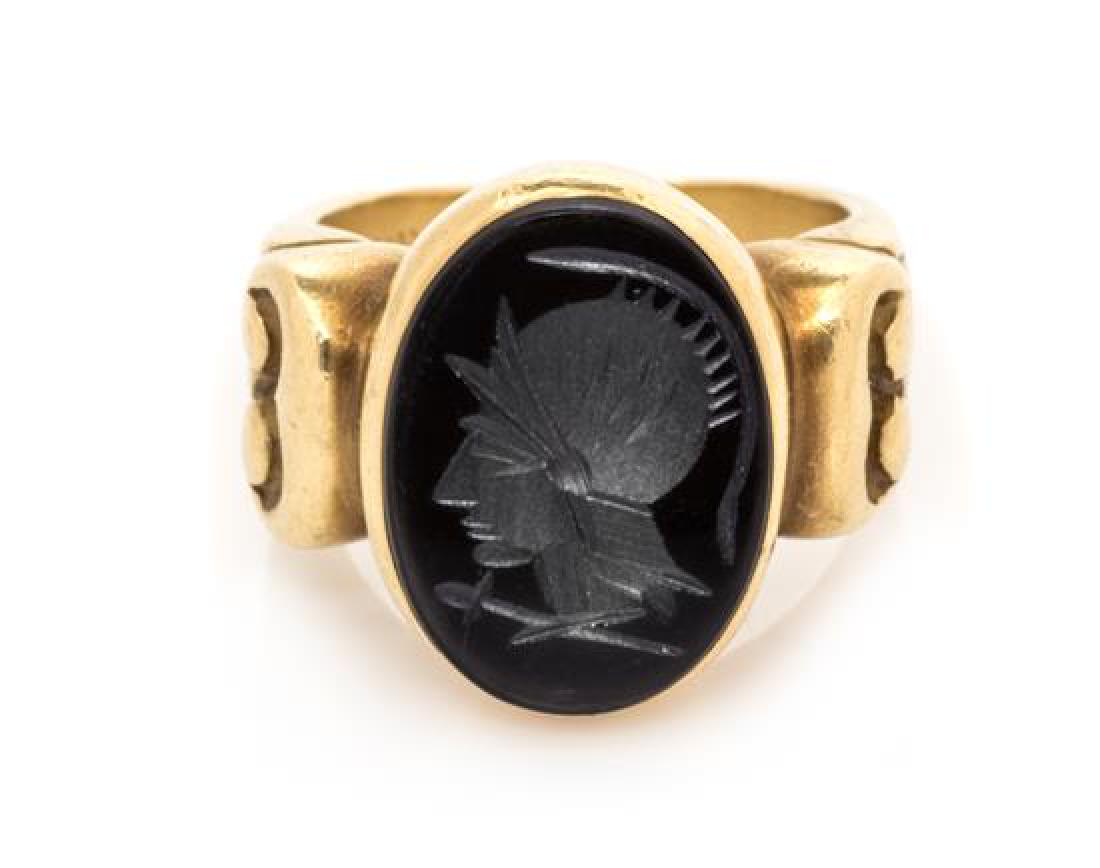 An 18 Karat Yellow Gold and Onyx Intaglio Ring, Vahe: An 18 Karat Yellow Gold and Onyx Intaglio Ring, Vahe Naltchayan, containing one oval onyx intaglio carved with a Classical Roman solder profile. Stamp: VAHE NALTCHAYAN T-M 1987 USA 18KT. 9.90 dwts. Es