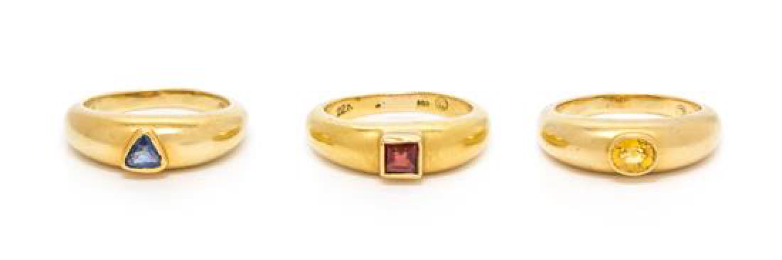 A Collection of 18 Karat Yellow Gold, Blue Sapphire,: A Collection of 18 Karat Yellow Gold, Blue Sapphire, Yellow Sapphire and Garnet Jewelry, Luna Felix, consisting of three rings, one set with a triangular mixed cut sapphire, one set with an oval mixed