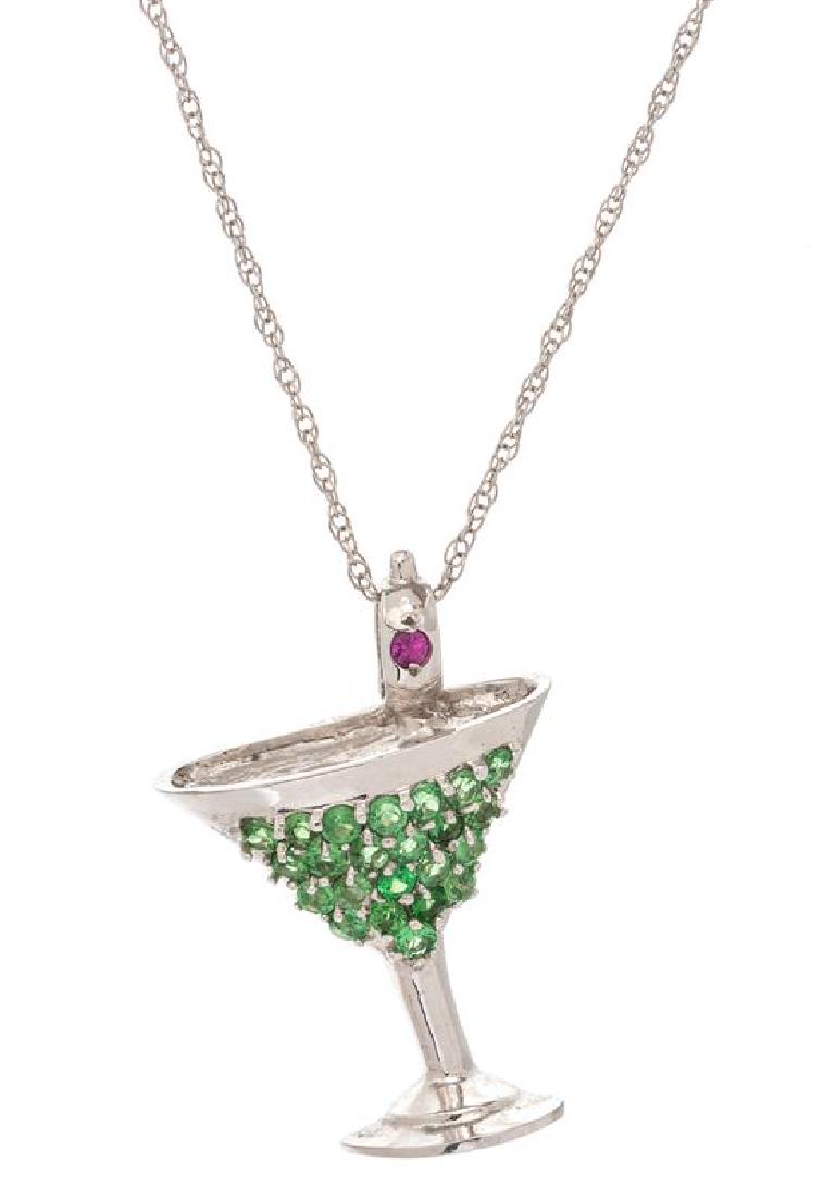A 14 Karat White Gold, Tsavorite Garnet and Ruby: A 14 Karat White Gold, Tsavorite Garnet and Ruby Martini Glass Pendant Necklace, containing 23 round mixed cut tsavorite garnets and one round mixed cut ruby, suspended from a 14 karat white gold cabl