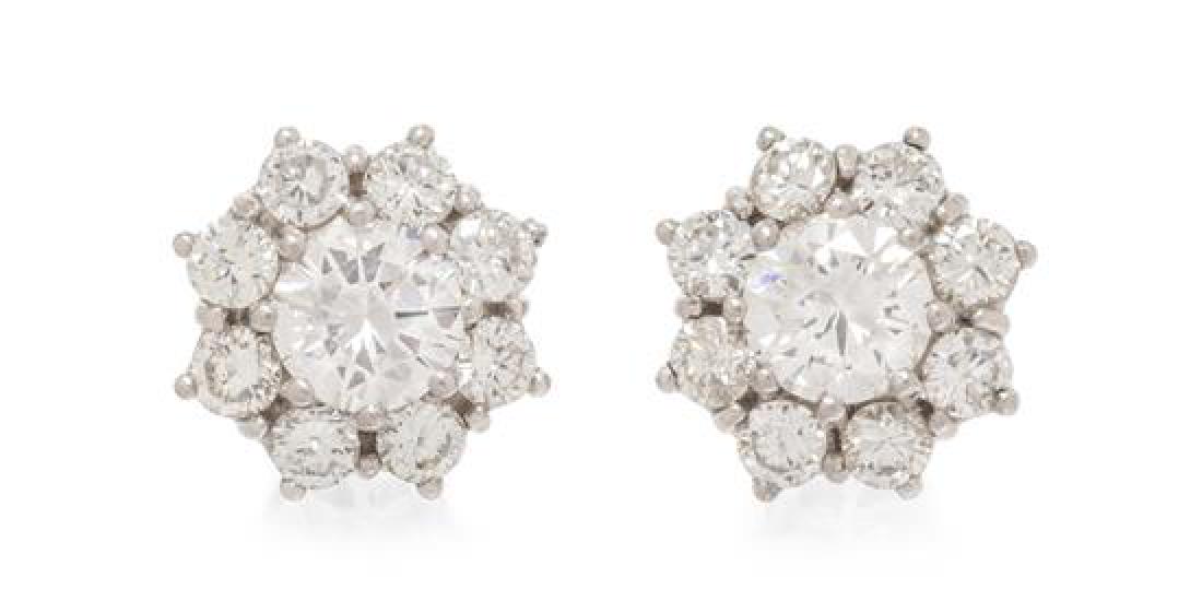 A Pair of Platinum and Diamond Cluster Earrings, 2.35: A Pair of Platinum and Diamond Cluster Earrings, containing two round brilliant cut diamonds weighing approximately 0.86 carat total surrounded by 16 round brilliant cut diamonds weighing approximatel