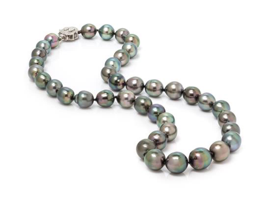 A 14 Karat White Gold, Diamond and Cultured Baroque: A 14 Karat White Gold, Diamond and Cultured Baroque Tahitian Pearl Necklace, consisting of 39 cultured Baroque Tahitian pearls measuring approximately 8.40-10.80 mm in diameter knot strung with a box 