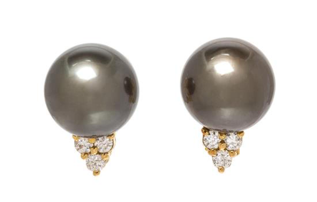 A Pair of 18 Karat Yellow Gold, Cultured Tahitian Pearl: A Pair of 18 Karat Yellow Gold, Cultured Tahitian Pearl and Diamond Earclips, containing two Tahitian pearls measuring approximately 11.60 mm in diameter and six round brilliant cut diamonds weighing 
