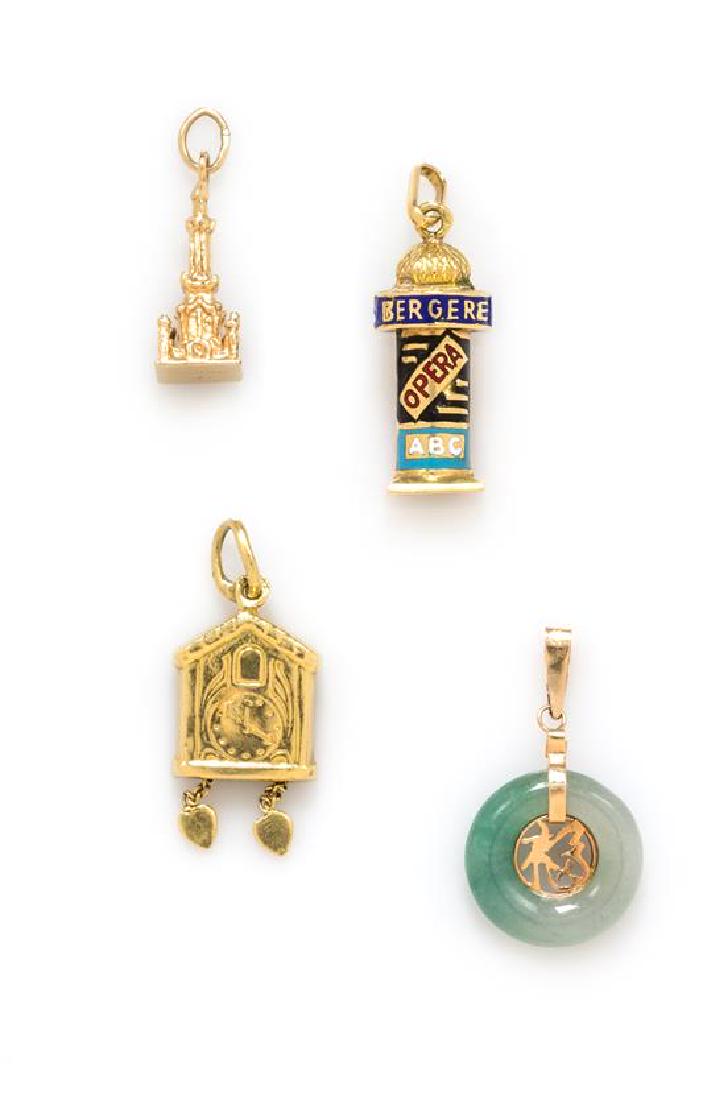 A Collection of Yellow Gold Charms, 3.40 dwts.: A Collection of Yellow Gold Charms, consisting of a polychrome enamelled Folies Bergere charm, a 14 karat gold and jade bi charm, a cuckoo clock charm and a 14 karat gold Water Tower charm. 3.40 dwts.