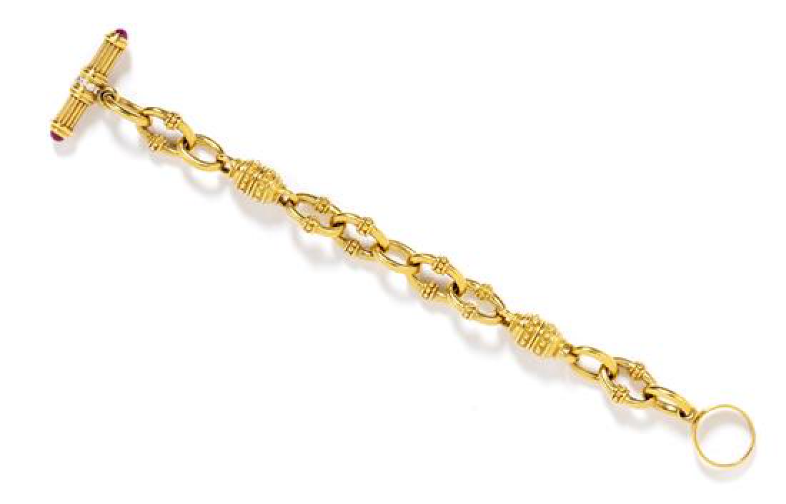 An 18 Karat Yellow Gold, Ruby and Diamond Bracelet,: An 18 Karat Yellow Gold, Ruby and Diamond Bracelet, Judith Ripka, consisting of fancy gold links with toggle clasp containing two round cabochon cut rubies measuring approximately 4.40 mm in diameter