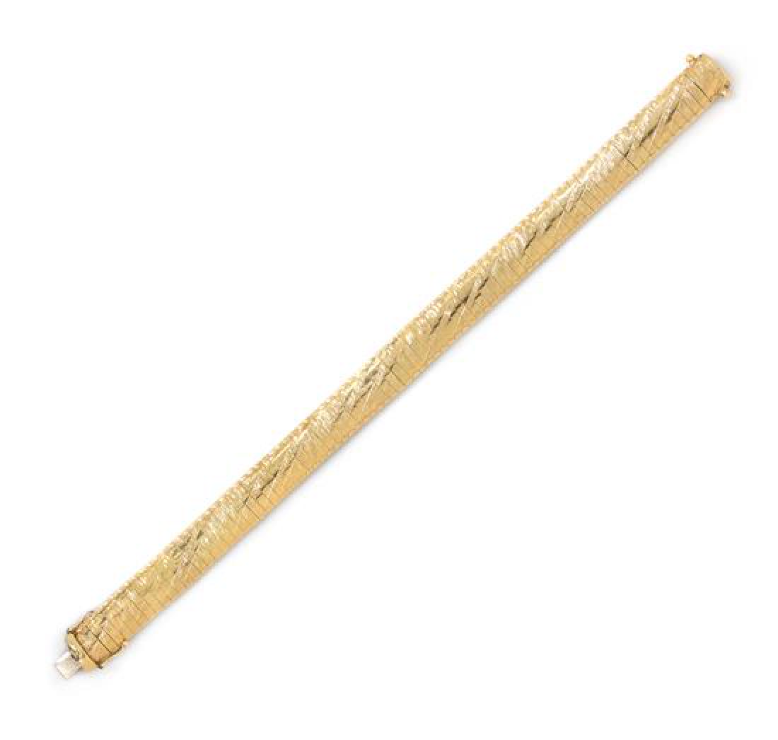 *A 14 Karat Yellow Gold Omega Link Bracelet, Aurafin,: *A 14 Karat Yellow Gold Omega Link Bracelet, Aurafin, consisting of an alternating polished and textured diagonal design, measuring approximately 9.00 mm wide. Stamp: 14K ITALY Aurafin 3. 9.50 dwts. E