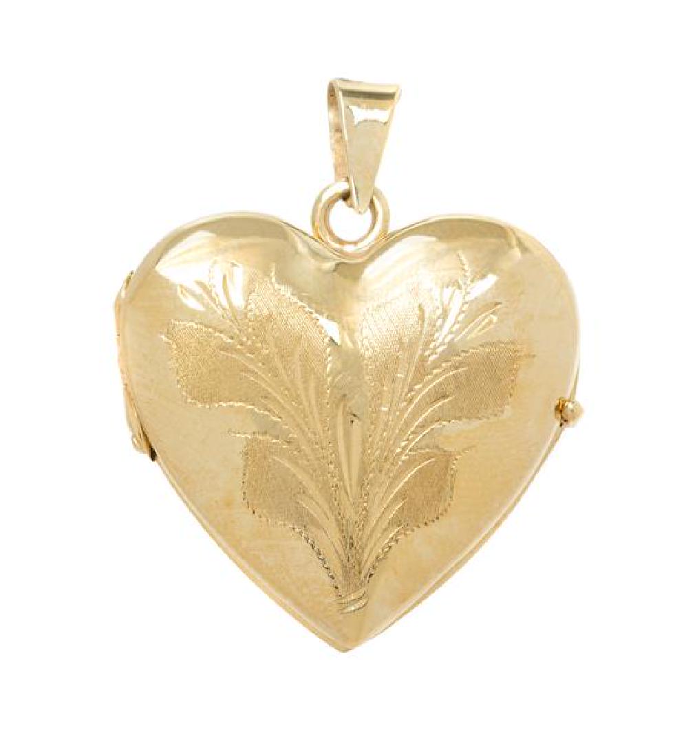 A 14 Karat Yellow Gold Heart Shape Locket, Italian,: A 14 Karat Yellow Gold Heart Shape Locket, Italian, with engraved foliate motif. Stamp: 14Kt Italy. 4.10 dwts. Estimate $150-250