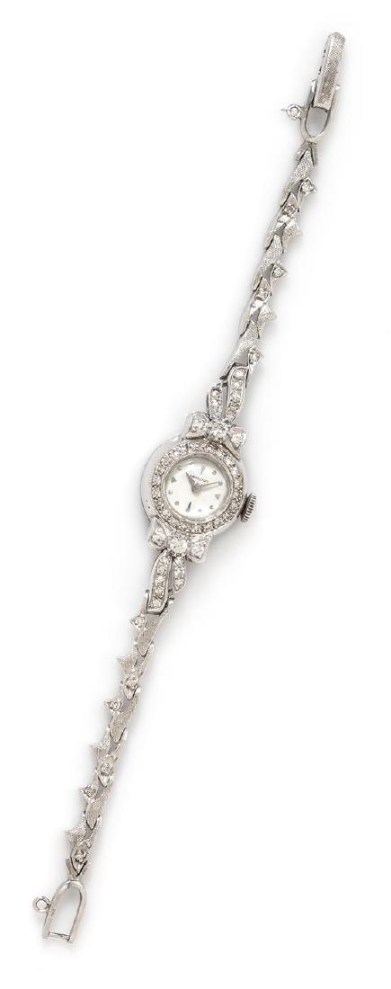 A 14 Karat White Gold and Diamond Wristwatch, Hamilton,: A 14 Karat White Gold and Diamond Wristwatch, Hamilton, 16.00 mm case diameter, off-white dial signed HAMILTON, applied dot and triangular numeral markers, alpha hands, snap on case back, coin edge cr