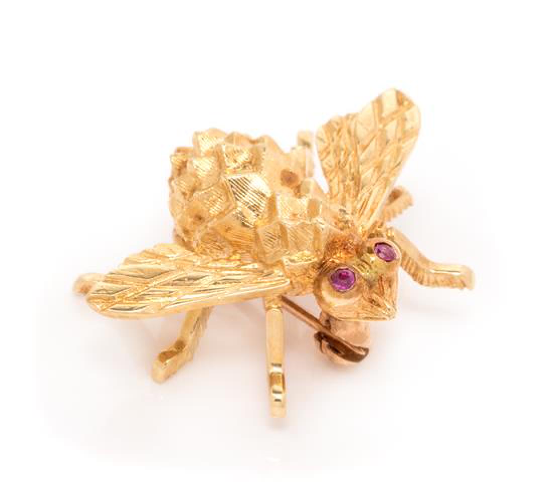 An 18 Karat Yellow Gold and Ruby Bee Brooch, Herbert: An 18 Karat Yellow Gold and Ruby Bee Brooch, Herbert Rosenthal, consisting of a textured gold bee containing two round mixed cut ruby eyes measuring approximately 1.00 mm in diameter. Stamp: 18K (make